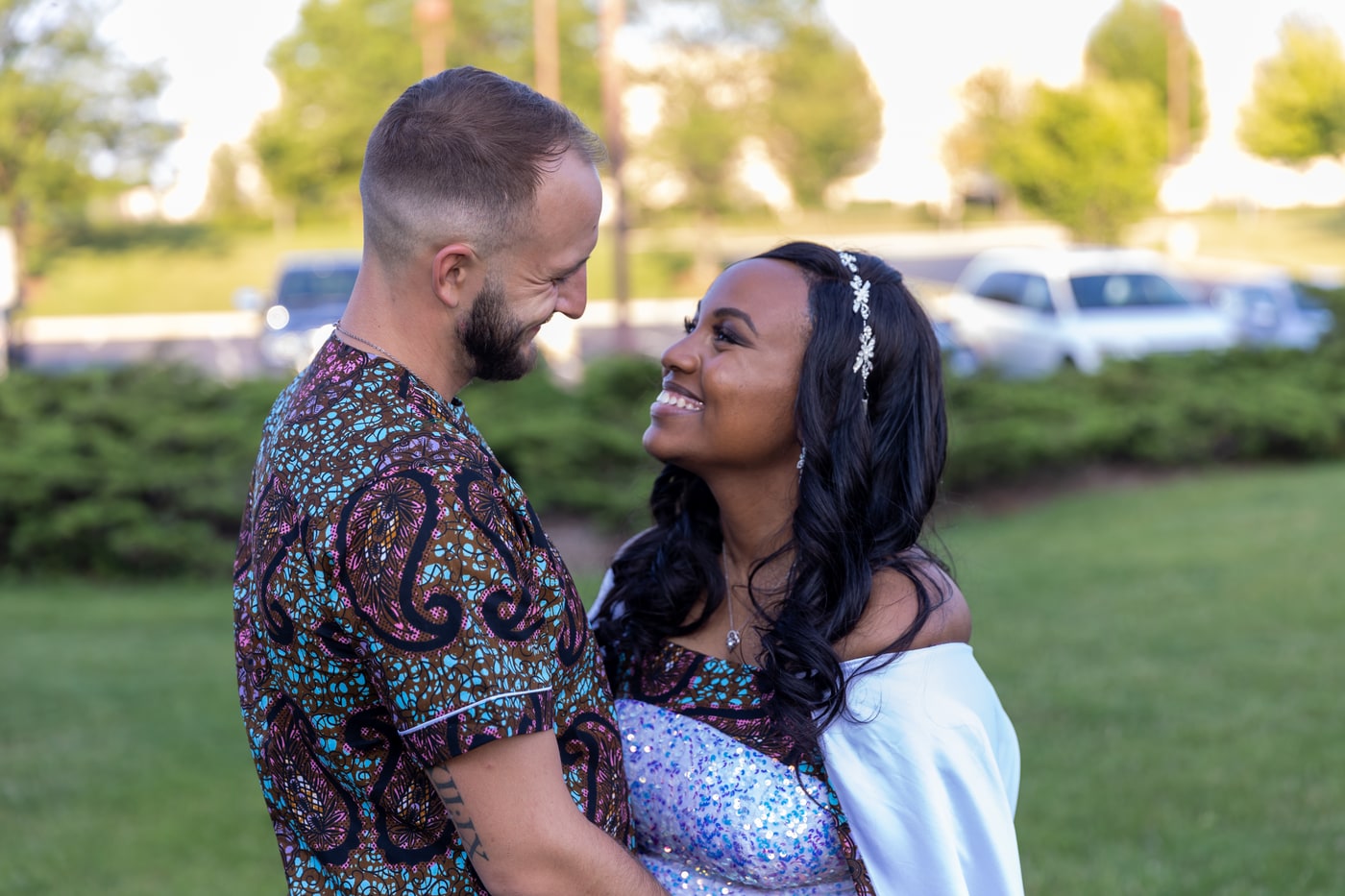 Engagement portrait with warm connection and open outdoor space.