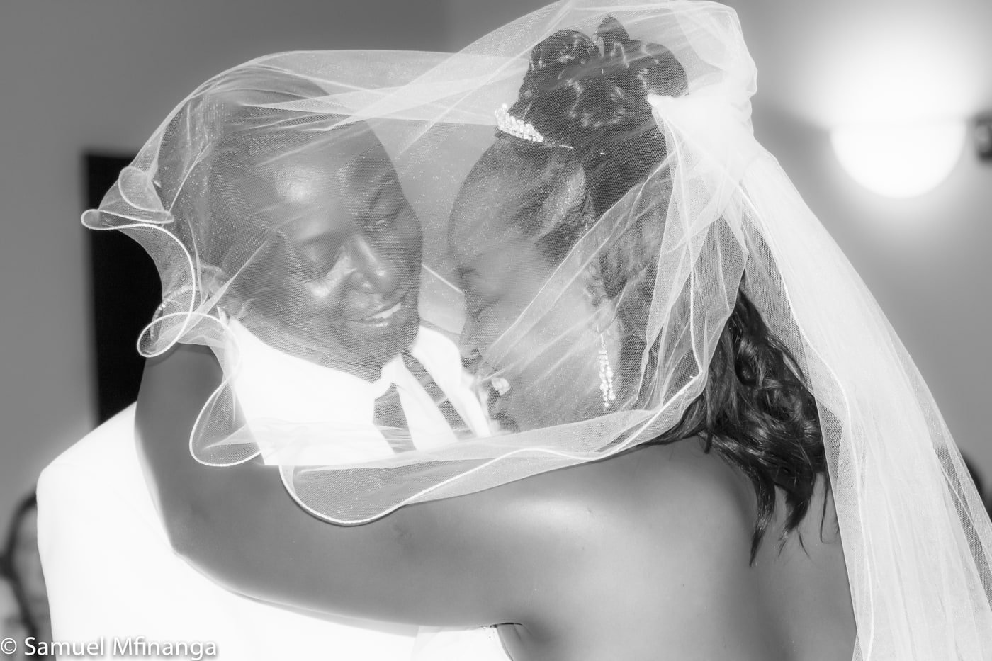 Wedding veil portrait with graphic black-and-white framing.