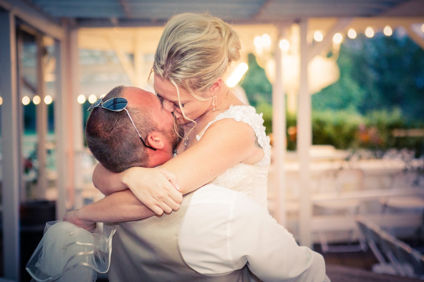 Wedding kiss at reception, candid moment.