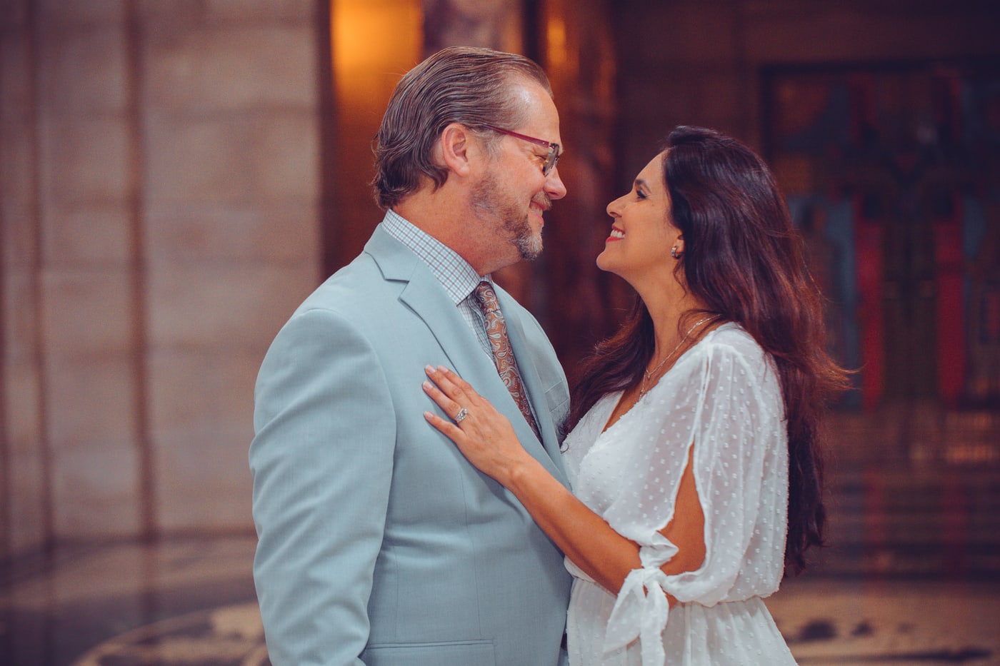 Warm wedding reception couple portrait.