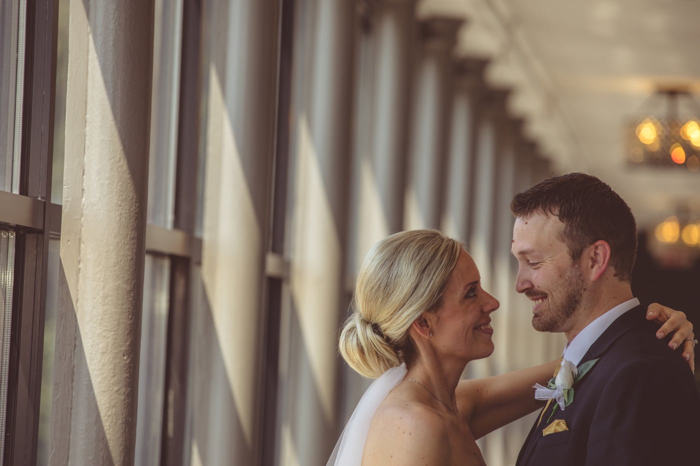 Wedding couple portrait by modern columns with elegant editorial spacing.